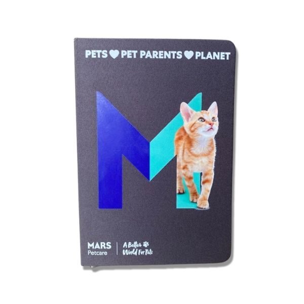 Mars Petcare notebook with a cat image and the letter 'M' in blue and green, featuring the slogan 'Pets ♥ Pet Parents ♥ Planet' and 'A Better World For Pets' tagline.